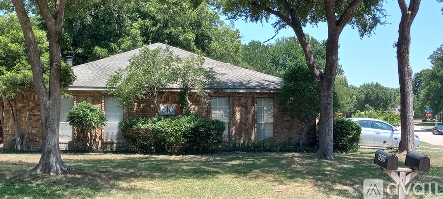 A house with a tree in front of it.