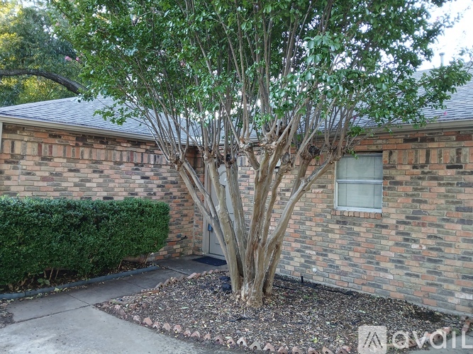 A house with a garage and a wall mounted air conditioner unit.