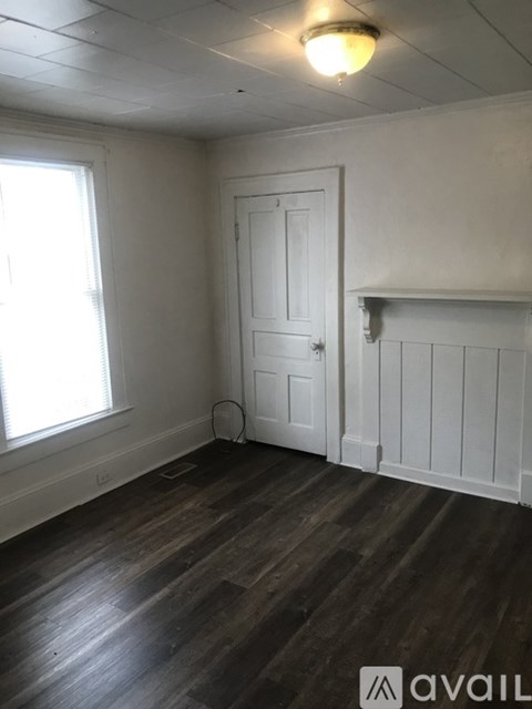 A room with wooden floors and white walls.