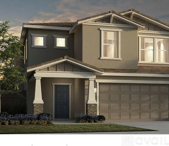 A modern house with a dark blue front door and a large garage door.