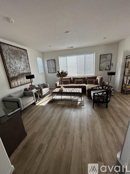 A living room with a brown sofa and a coffee table.