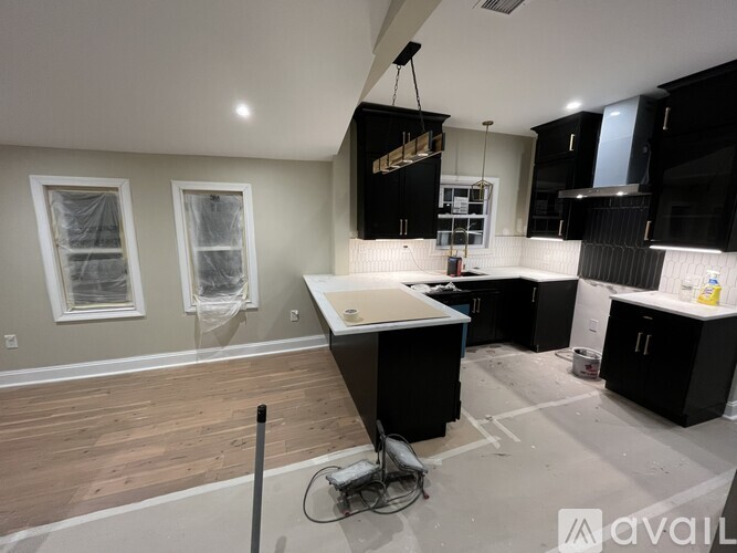 A kitchen under construction with a vacuum cleaner on the floor.