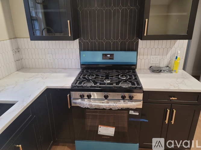 A blue stove top oven with a white tile backsplash.