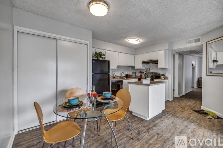 A kitchen with a dining table and chairs.