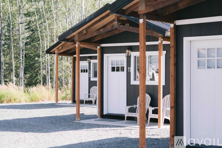 A small white house with a wooden porch and a white door.