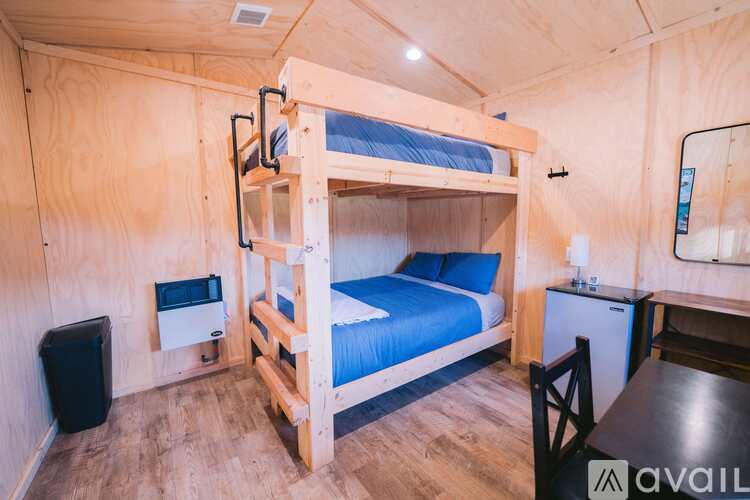 A bedroom with a bunk bed and a small table.
