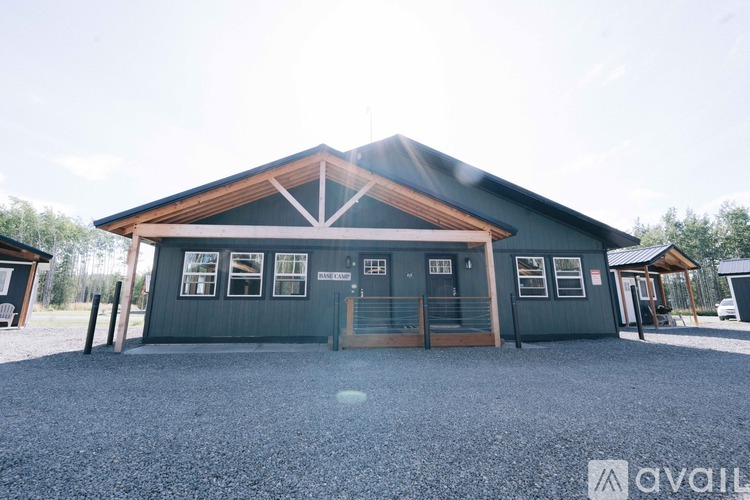 A large building with a gravel driveway in front.