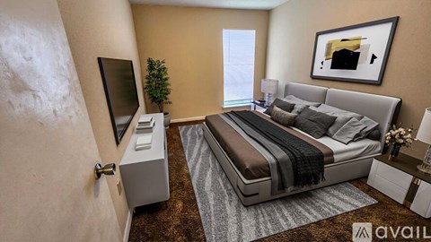 A modern bedroom with a large bed, a flat-screen TV, and a small plant.