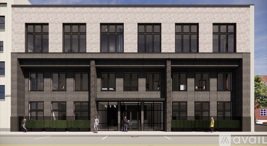 A modern building with a large glass entrance and a row of windows on the ground floor.