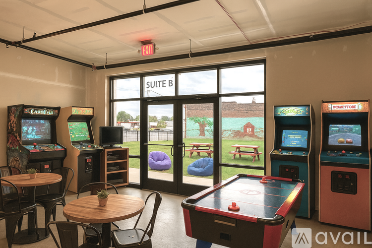 A room with arcade games and a pool table.