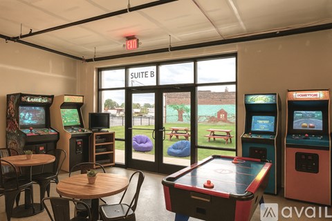 A room with arcade games and a pool table.