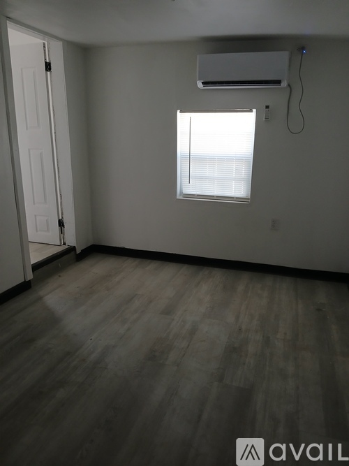 A room with a window and a door.