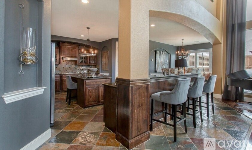 A kitchen with a bar area and a dining table.