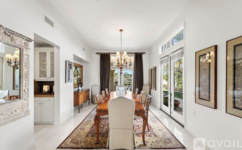 A dining room with a table set for six.