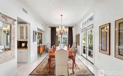 A dining room with a table set for six.