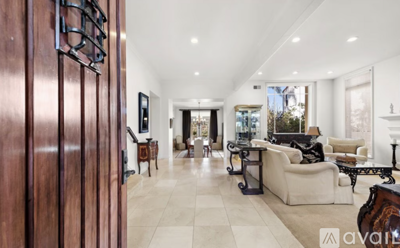 A living room with a white couch and a wooden door.