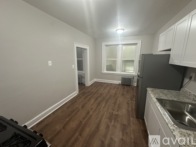 A kitchen with a stove top oven and a sink.