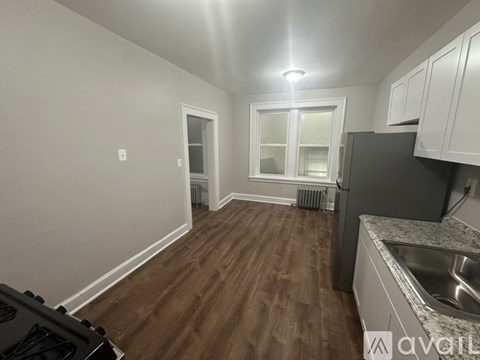 A kitchen with a stove top oven and a sink.