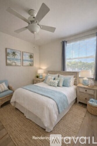 A bedroom with a bed, nightstands, and a ceiling fan.