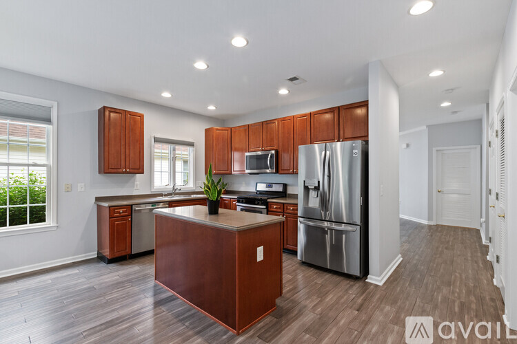 A kitchen with wooden cabinets and a central island.