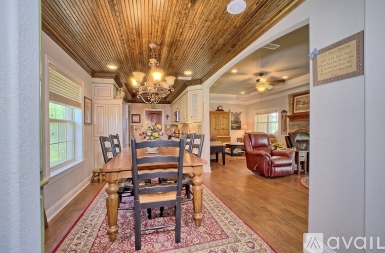 A dining room with a wooden table and chairs.