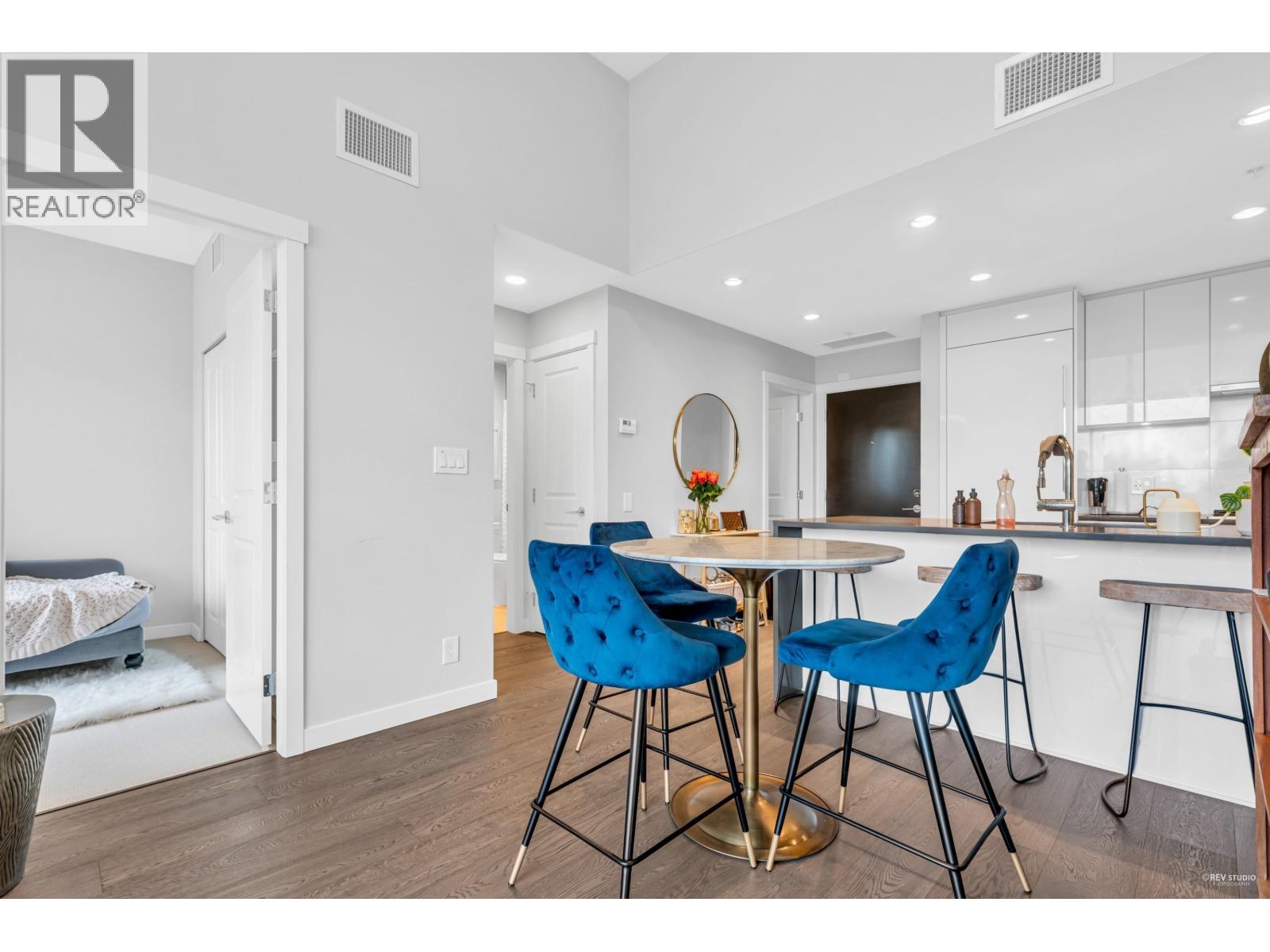 A modern kitchen with a dining table and chairs.