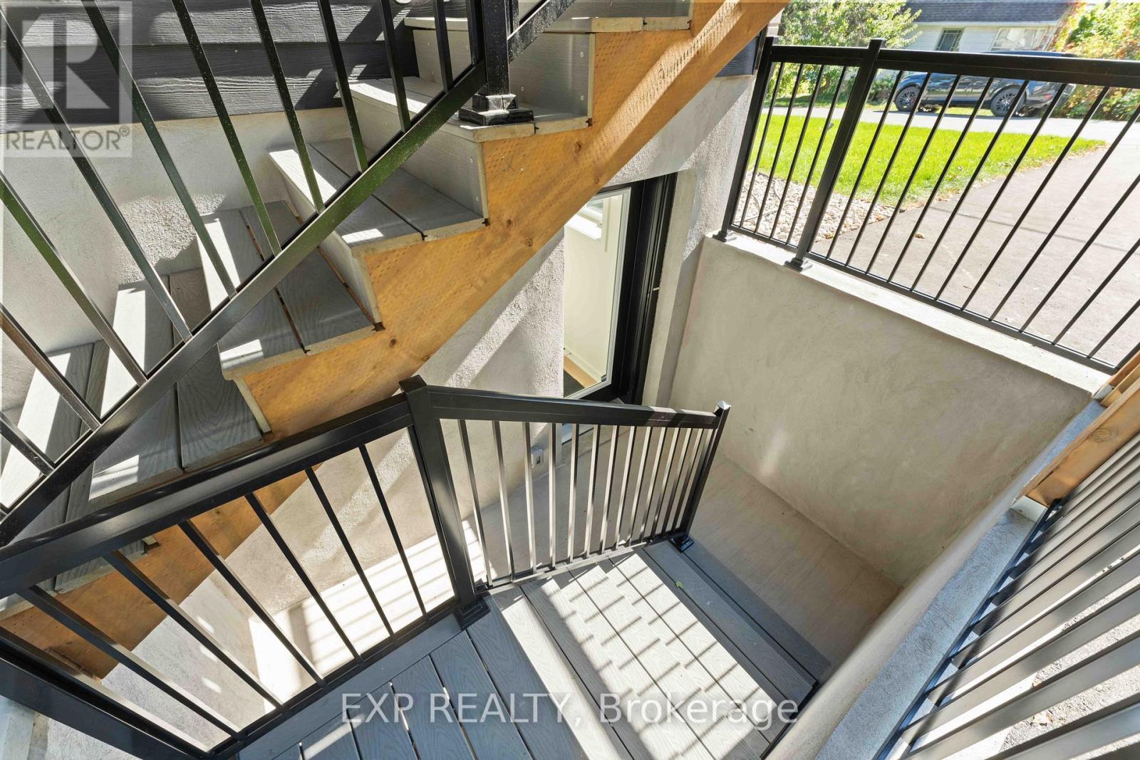 A spiral staircase with a metal railing and wooden steps.