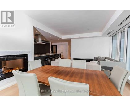 A dining room with a fireplace and a wooden table.