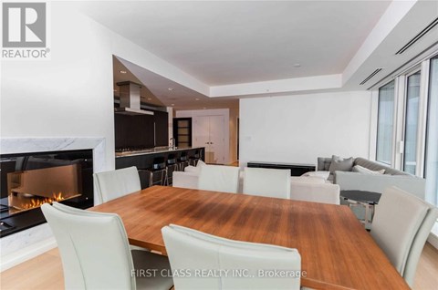 A dining room with a fireplace and a wooden table.