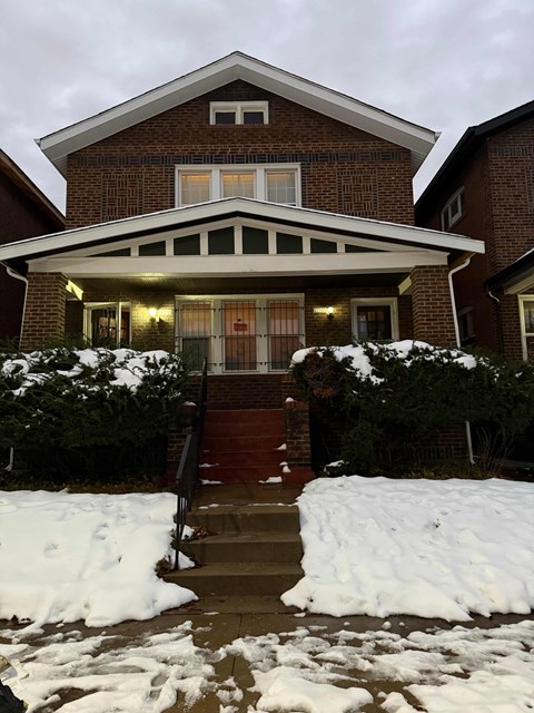A house with a red brick exterior and a white roof.
