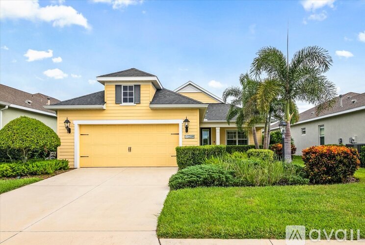 A house with a yellow garage door is for sale.