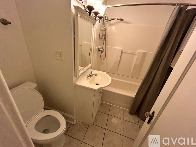 A bathroom with a toilet, sink, and bathtub.