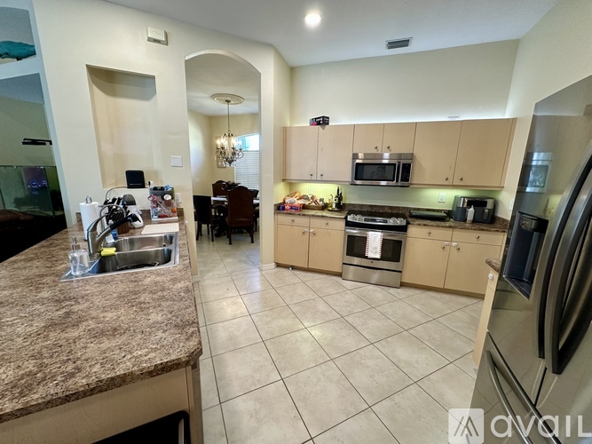 A kitchen with granite countertops and stainless steel appliances.