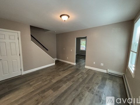 A house with a porch and a chimney is for sale.