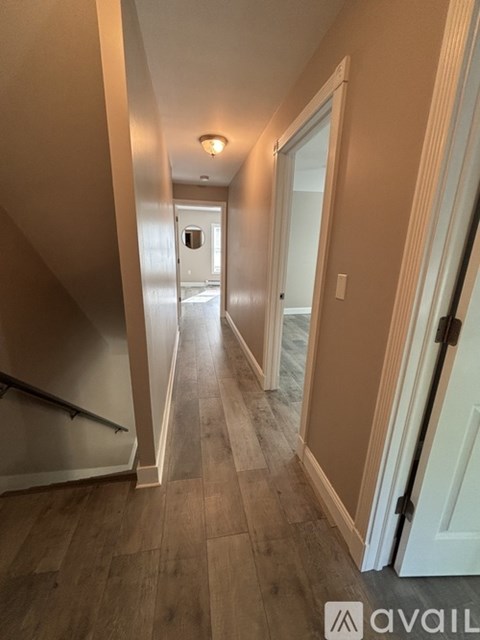 A hallway with a door leading to a bedroom.