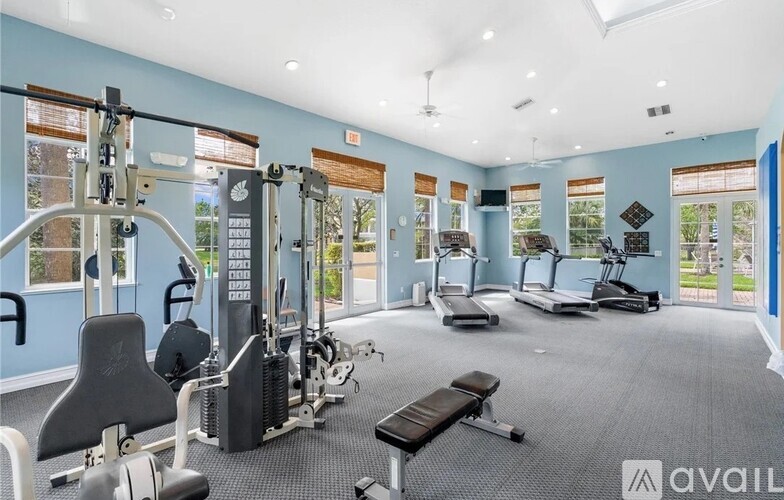 A well-equipped gym with various exercise machines and a bench.