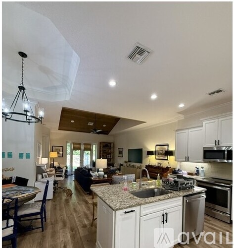 A well-lit kitchen with a dining table and chairs.