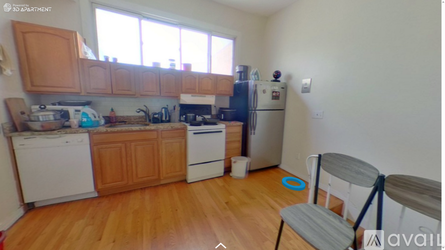 A kitchen with wooden cabinets and a white fridge.