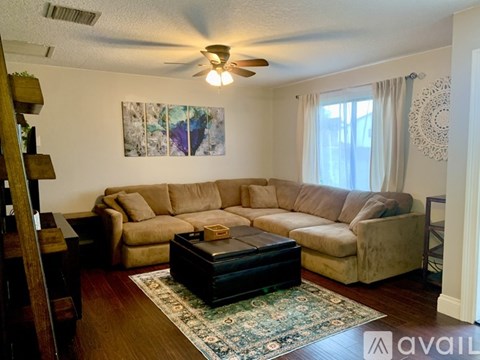 A living room with a large sectional sofa and a coffee table.