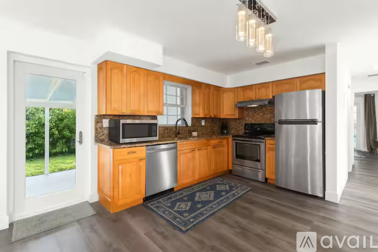 A kitchen with wooden cabinets and stainless steel appliances.
