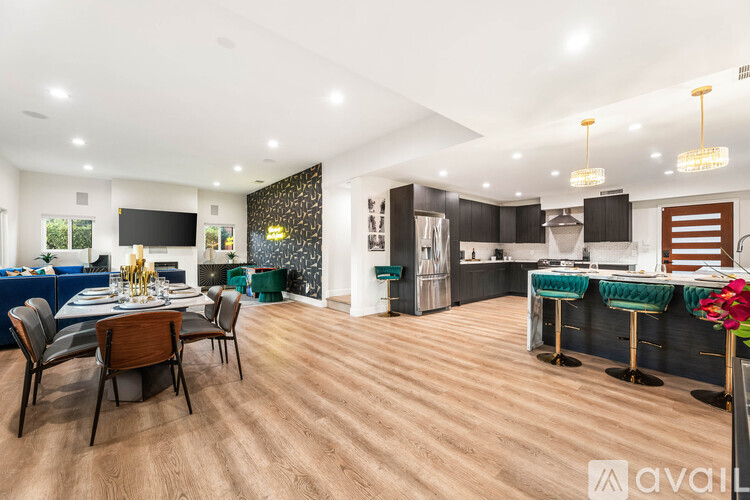 A modern kitchen with a dining table set for four.