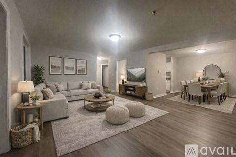 A well-lit, modern living room with a variety of furniture and decor.