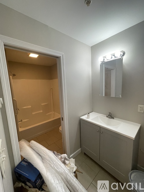 A bathroom with a white sink and a white cabinet.