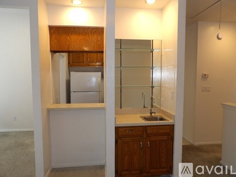 A kitchen with a sink and a refrigerator.