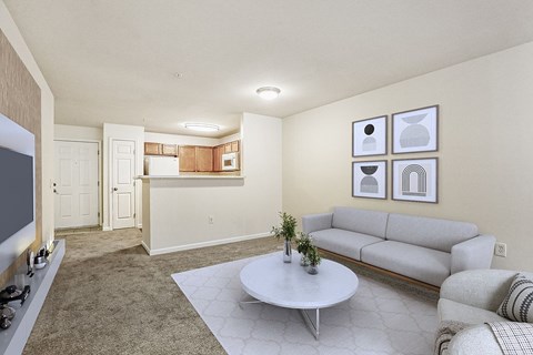 A living room with a grey couch and a white coffee table.