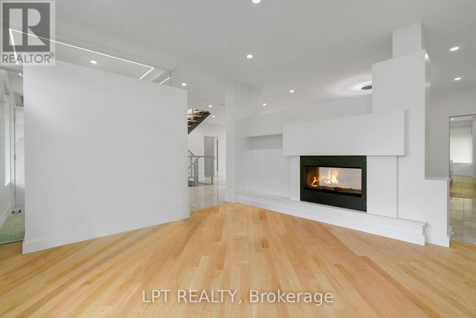 A modern living room with a fireplace and wooden floors.