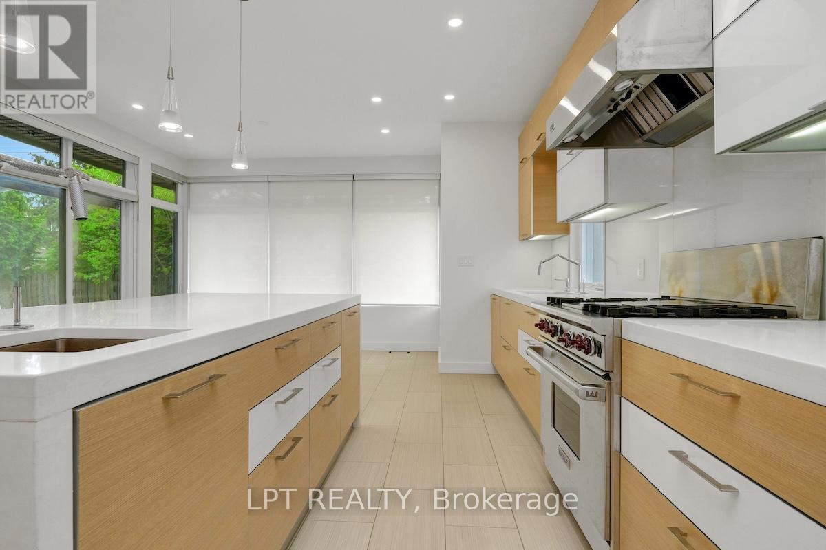 A modern kitchen with wooden cabinets and stainless steel appliances.