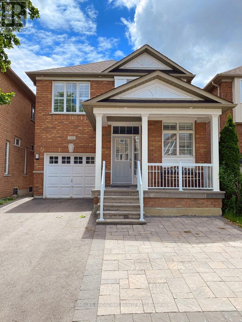 A brick house with a white door and windows.