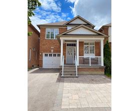 A brick house with a white door and windows.