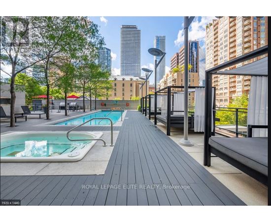 A pool area with a bench and a pool with water.